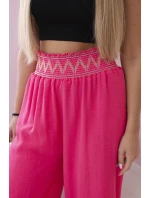 Nohavice so širokým elastickým pásom ružovej farby