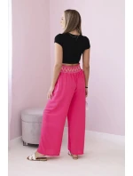 Nohavice so širokým elastickým pásom ružovej farby